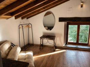 a living room with a couch and a mirror at Laguna de Valfría in Fresneda