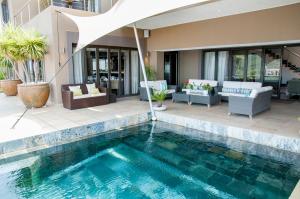 a swimming pool in the middle of a house at The Mount Knysna in Knysna