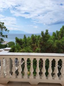 a balcony with a view of the ocean at Ferienwohnung mit Meerblick in Povile +6 photos
