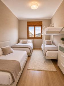 a bedroom with three bunk beds and a window at CaL QuEROL Llivia 2 piscina, 8 pax, 2 baños y parking in Llivia +8 photos