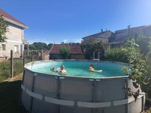 a group of people in a swimming pool at Casa YaraMaya in Carballino
