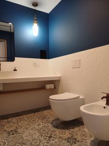 a bathroom with a white toilet and a sink at Hotel Dom Marynarza in Gdynia