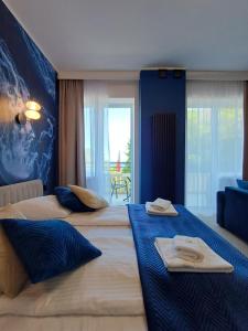 a hotel room with two beds with towels on them at Hotel Dom Marynarza in Gdynia
