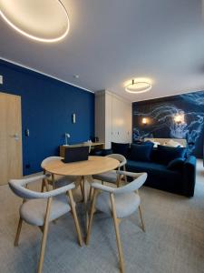 a living room with a table and chairs and a couch at Hotel Dom Marynarza in Gdynia