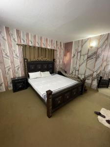 a bedroom with a large bed in a room at Hillcrest Terraces Bhurban in Rāwāt
