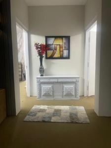 a living room with a vase of flowers on a table at Hillcrest Terraces Bhurban in Rāwāt