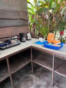 a table with plates and utensils on it at Cabañas MOHE’S Uvita in Uvita