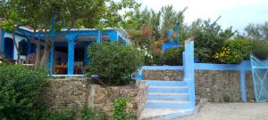 a blue house with stairs in front of it at panorama view in Chefchaouen