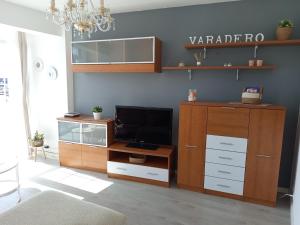 a living room with a entertainment center with a tv at VT Varadero in Fisterra