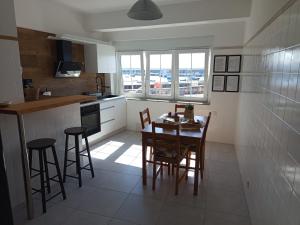 a kitchen with a table and chairs in a kitchen at VT Varadero in Fisterra +9 photos