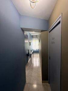a hallway with a door and a table in a room at Appartement Cuvier in Roubaix