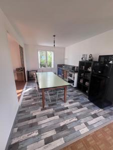 a kitchen with a table in the middle of a room at Le Gîte de Saint Romans in Saint-Romans-lès-Melle