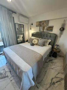 a bedroom with a large bed in a room at Artion Jacuzzi Villa Nikiti in Nikiti