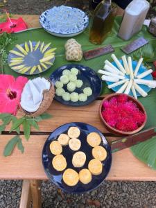 a table with plates of food and flowers on it at Dolphin Quest Apartment #1 in Pavones +104 photos