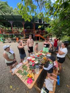 a group of people standing around a picnic table at Dolphin Quest Apartment #1 in Pavones