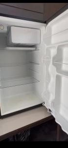 an empty refrigerator with its door open at Cabañas MOHE’S Uvita in Uvita