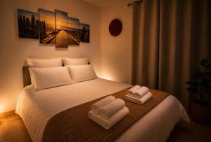 a bedroom with a bed with two towels on it at Horizon Bleu Canet in Canet-en-Roussillon +18 photos