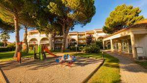 a playground in front of a building at Horizon Bleu Canet in Canet-en-Roussillon