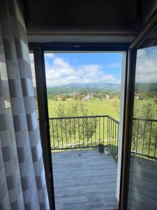 a view of a balcony with a view of a field at Peaceful Cottage in Bijelo Polje