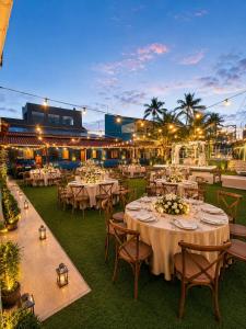 a restaurant with white tables and chairs and lights at Pousada Fast Inn in Guarujá