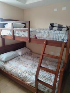 a room with two bunk beds and a bed at HOSPEDAJE YACUCALLE in Ibarra