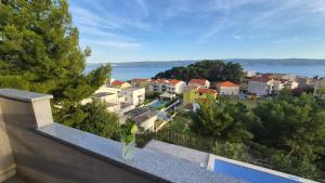 a balcony with a view of a town and the water at Villa Stanić in Omiš