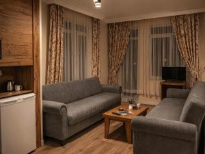a living room with a couch and a table at Bella Rose Apart Hotel, Alanya in Alanya