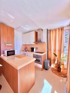 a kitchen with wooden cabinets and a counter top at Brisa Mediterránea Torrox Costa in Torrox Costa