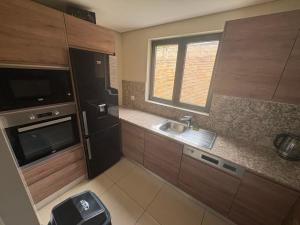 a small kitchen with a sink and a microwave at Waterfront - B luxury in Dakar