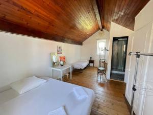 a bedroom with two beds and a wooden ceiling at La Canetterie in Dole