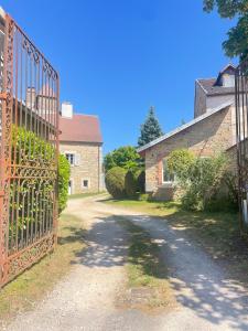 an entrance to a house with an iron gate at La Canetterie in Dole +4 photos