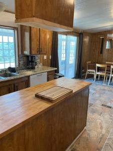 a kitchen with wooden cabinets and a wooden counter top at Sunsets and City Lights 3BD 2Bath in Miramonte