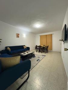 a living room with a couch and a table at Dar KAMOUN - 2BR Apts with 5G WiFi & Parking, Houmt Souk & Corniche in Houmt Souk