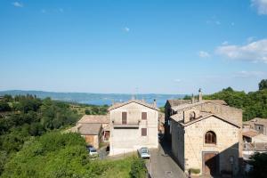 a group of buildings on a hill with trees at alloggio belvedere nel borgo in Gradoli