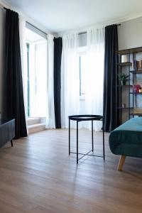 a living room with a table and some windows at alloggio belvedere nel borgo in Gradoli