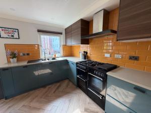 a kitchen with a stove and a sink in it at Right Choice by 3 Crowns in Dundee