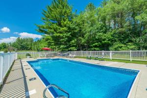 a swimming pool in a yard with a fence and trees at The Landgrove in North Landgrove