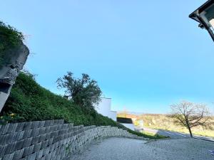 a stone path next to a retaining wall at ESER Hotel Pension in Beuggen
