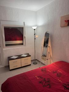 a bedroom with a bed and a dresser and a mirror at Apartmani Kruče in Ulcinj