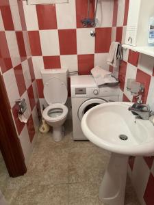 a bathroom with a toilet and a sink at Apartmani Kruče in Ulcinj +8 photos