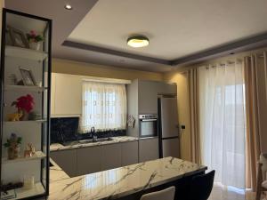 a kitchen with a table and a counter top at Villa Kalo in Blerimas