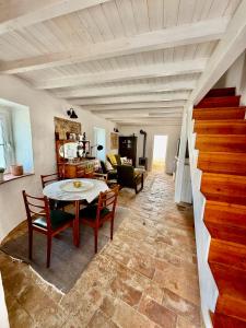 a living room with a table and chairs at Casa Alma Clara in Odemira