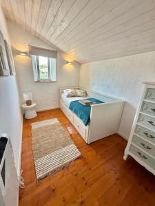 a small bedroom with a bed in a attic at Casa Alma Clara in Odemira