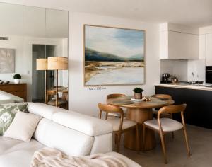 a living room with a white couch and a table at Cairns Waterfront Luxury at Harbourlights in Cairns