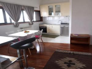 a kitchen with a table and chairs in a room at Sweets Suites Espinho in Espinho