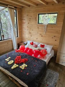 a bedroom with a bed with red peppers on it at cabaña sol in Santa Elena