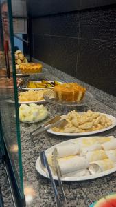 a buffet with plates of food on a counter at Pousada Paraíso in Carolina +3 photos