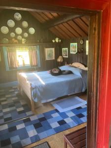 a bedroom with a large bed in a room at Egen stuga med delat badrum in Norrtälje