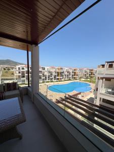 a balcony with a view of a swimming pool at New Luxury apartment with 3 pool in Cabo Negro