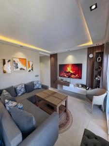 a living room with a couch and a table at New Luxury apartment with 3 pool in Cabo Negro